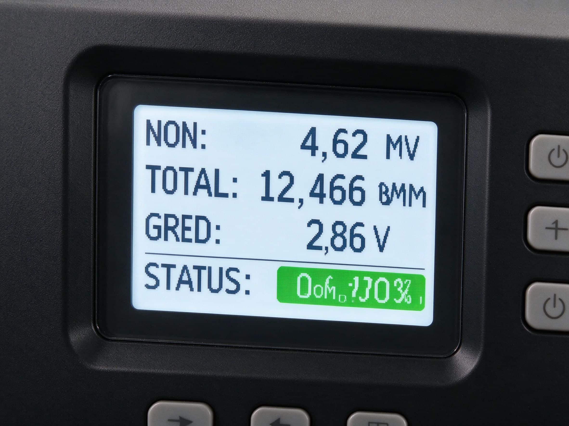 Close-up of solar inverter LCD screen showing power generation data